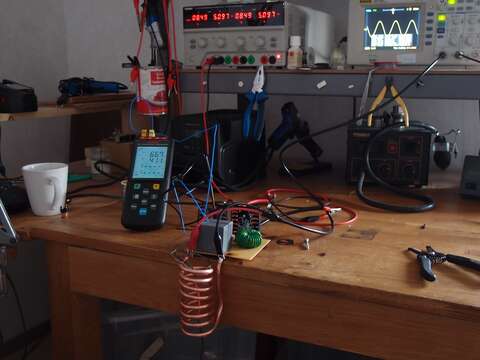 Picture of the setup. Glowing iron wire is visible.